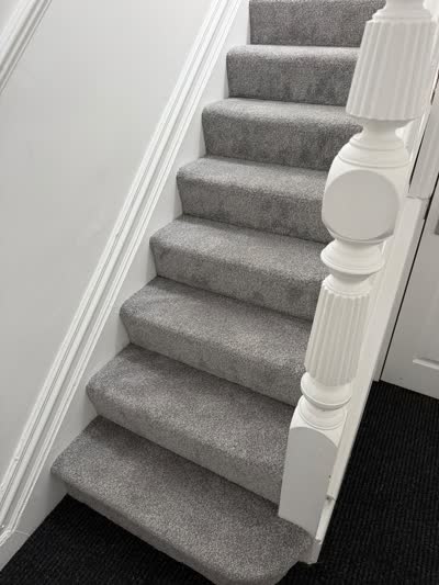 Grey carpet fitted on the stairs, viewed from the side